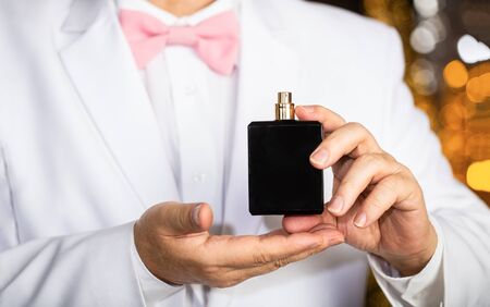 Man scent perfume. Perfume or cologne bottle. Fashion cologne bottle. Rich man prefers expensive fragrance smell. Fragrance smell. Male fragrance, perfumery, cosmetics. Smell perfume. Expensive suitの写真素材