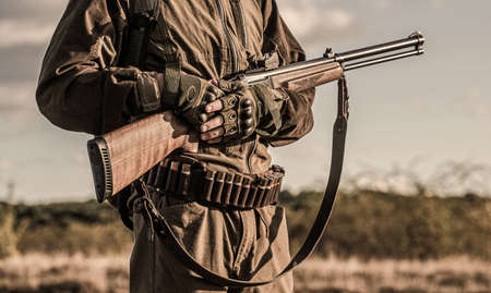 Hunter man. Hunting period, autumn season. Male with a gun. A hunter with a hunting gun and hunting...