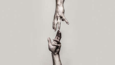 Close up help hand. Helping hand concept and international day of peace, support. Two hands, helping arm of a friend, teamwork. Black and whiteの写真素材