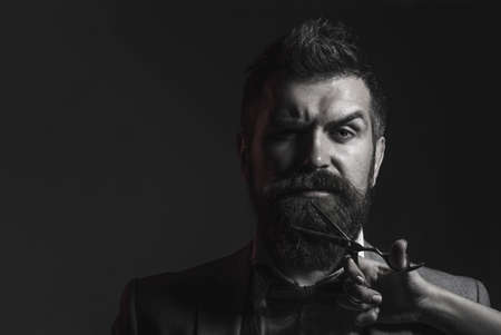 Barber scissors and straight razor, barbershop. Mens haircut, shaving. Bearded man, long beard,...