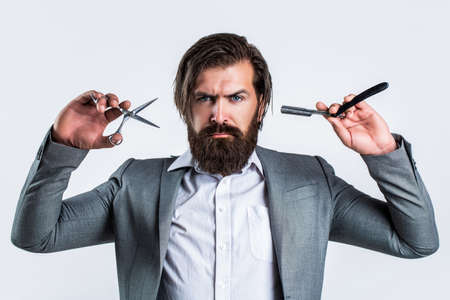 Brutal guy, scissors, straight razor. Bearded client visiting barber shop. Barber scissors and...