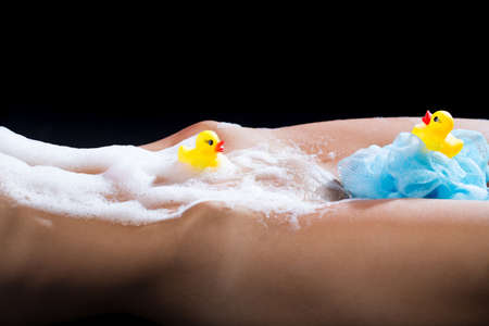 Temptation. Erotica. Soap foam. Shower gel. Sexy body. Girl washing her body. Sexy girl with ducks...