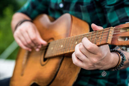 Acoustic guitars playing. Music concept. Guitars acoustic. Live music. Music festival. Male musician...