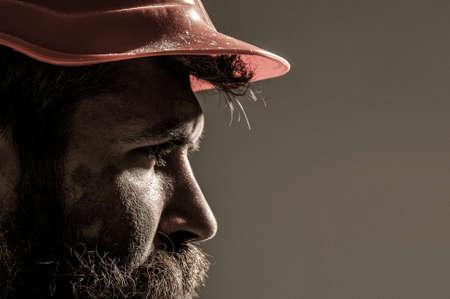 Bearded man worker with beard in building helmet or hard hat. Portrait architect builder, civil engineer working. Man builders, industryの写真素材