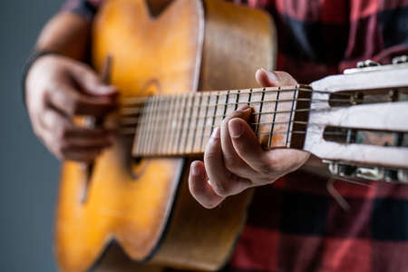 Mans hands playing acoustic guitar, close up. Acoustic guitars playing. Music concept. Guitars...
