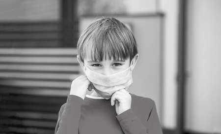 Coronavirus epidemic. Boy with protection facemask. Coronavirus quarantine. Health care. Face mask for protection coronavirus outbreak. Child wearing a medicine mask outdoorsの写真素材