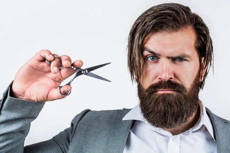 Barber scissors. Vintage barbershop, shaving. Male in barbershop, haircut, shaving. Bearded man isolated on gray background. Mans haircut in barber shop. Barber scissors, barber shopの写真素材