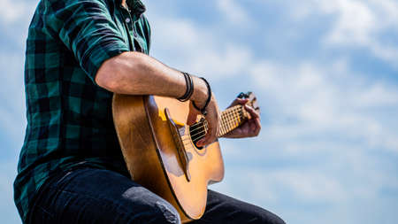 Guitars acoustic. Male musician playing guitar, music instrument. Mans hands playing acoustic guitar, close up. Acoustic guitars playing. Music conceptの写真素材