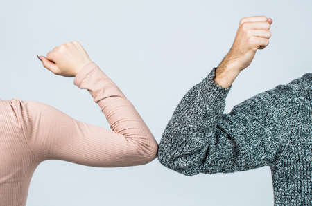 Elbows bump. Health care concept. Social distancing. Two people bump elbows to avoid coronavirus. Coronavirus epidemic. Closeup elbow bumpの写真素材