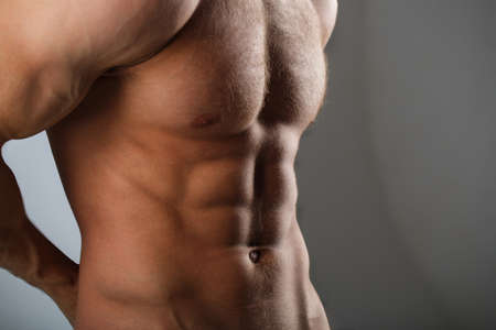 Muscular torso and chest. Isolated on black background