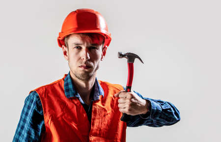 Man builder isolated on white background. Hammer hammering. Builder in helmet, hammer, handyman, builders in hardhat. Man worker with beard, building helmet, hard hatの写真素材