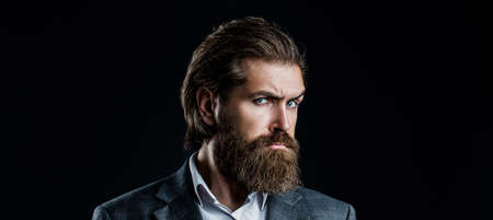 Portrait of handsome bearded man in suit. Male beard and mustache. Sexy male, brutal macho, hipster....