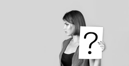 Question mark, symbol. Woman with doubtful expression and question marks. Black and white