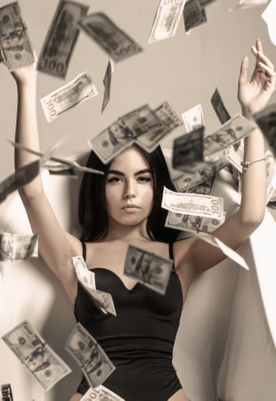 Rich sexy woman lies on money. Currency, women, winning. Sexy female and dollar bills. Sexy woman lying in dollar bills. Woman with lot of money.の写真素材