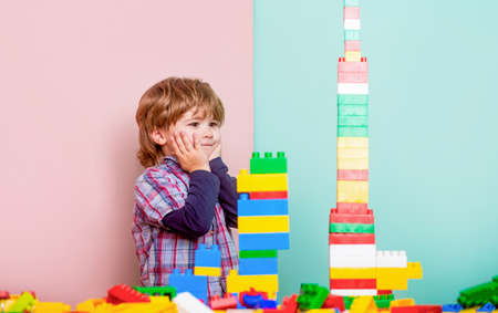 Boy playing with construction blocks at kindergarten. Child playing with colorful toy blocks. Educational toys for young children. Little boy playing with lots of colorful plastic blocks constructorの写真素材