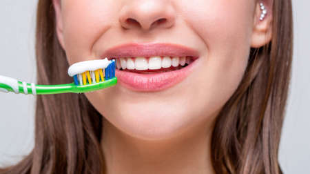 Dental health background. Close up of perfect and healthy teeth with toothbrush. Portrait of a...