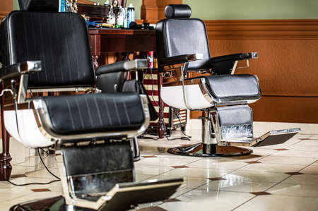 Stylish vintage barber chair. Professional hairstylist in barbershop interior. Barber shop chair. Barbershop armchair, modern hairdresser and hair salon, barber shop for men. Beard, bearded manの写真素材
