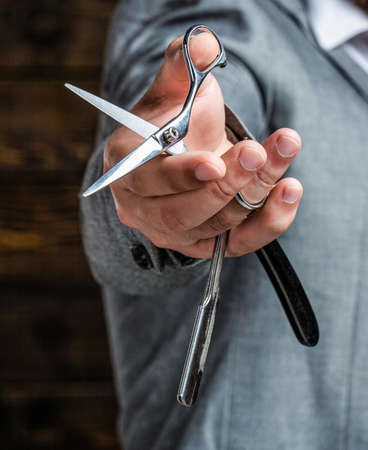 Vintage barber shop, shaving. Vintage barbershop. Brutal guy, scissors, straight razor. Bearded...