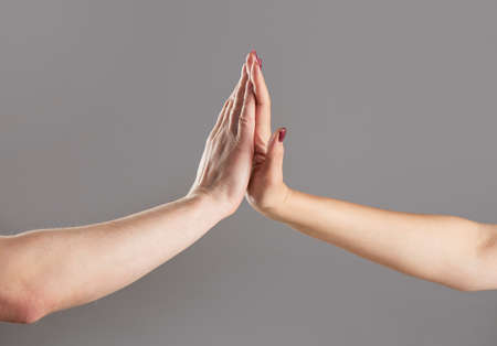 Man and girl giving high five. Two hands, male and female. High-five gesture and tenderness of...