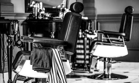 Barbershop armchair, modern hairdresser and hair salon, barber shop for men. Stylish vintage barber chair. Black and whiteの写真素材