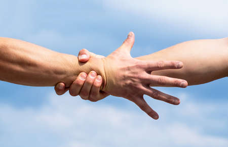Rescue, helping gesture or hands. Close up help hand. Helping hand concept, support. Friendly handshake. Two hands, shaking handsの写真素材