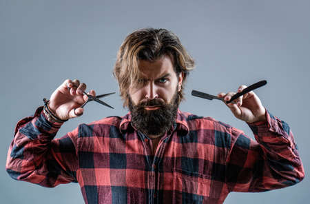 Barber scissors and straight razor, barber shop, suit. Vintage barber shop, shaving. Portrait bearded man. Mustache men. Brutal guy, scissors, straight razor. Bearded client visiting barber shopの写真素材