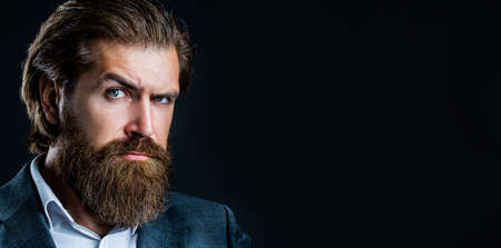 Portrait of handsome bearded man in suit. Male beard and mustache. Sexy male, brutal macho, hipster. Elegant handsome man in suit. Handsome bearded businessmanの写真素材