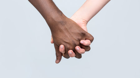 Black and white hand Love Partnership. Black, White Woman and man Holding Hands Together. White Woman, African man Holding Hand Friendship Symbol. African Peace Symbol. Mixed race couple holding handの写真素材