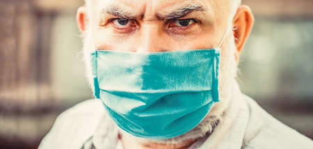 Coronavirus, illness, infection, quarantine, medical mask. Old man wearing face mask.