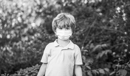 Child wearing face mask during virus and flu outbreak. Boy in a surgical bandageの写真素材