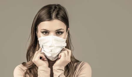 Girl Wearing Protective Mask. Woman wearing surgical mask for virus. Woman wearing an anti virus protection mask. Woman wearing medical face maskの写真素材