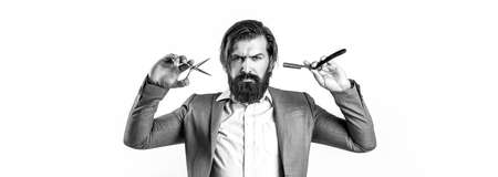 Barber scissors and straight razor, barber shop, suit. Vintage barber shop, shaving. Brutal guy, scissors, straight razor. Bearded client visiting barber shopの写真素材