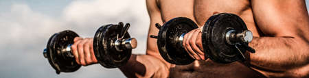 Strong bodybuilder. Muscles with dumbbell. Man training with dumbbells. Dumbbell. Muscular...