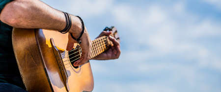 Guitars acoustic. Male musician playing guitar, music instrument. Mans hands playing acoustic...
