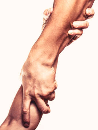 Close up help hand. Two hands, helping arm of a friend, teamwork. Rescue, helping gesture or handsの写真素材