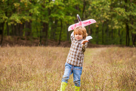 Happy child playing. Happy child playing outdoors. Happy boy play airplane. Little boy with plane. Child playing with toy airplaneの写真素材