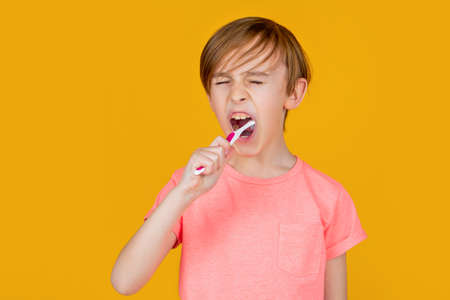 Little man brushing teeth. Happy child kid boy with toothbrush. Health care, dental hygiene. Little...