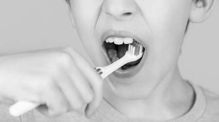 Little boy cleaning teeth with kids toothbrush. Dental hygiene. Little man brushing teeth. Happy...