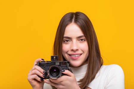 Girl using a camera photo. Photographer camera photo, Girl with a cameras. Woman holding camera. photographing girl joy make photography taking conceptの写真素材