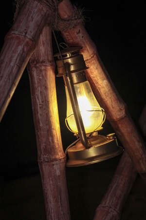 Oil lamp, petrol lamp on bambooの写真素材