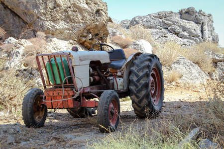 old tractor between rocks