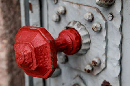Detail of a door lock with a red knobの写真素材