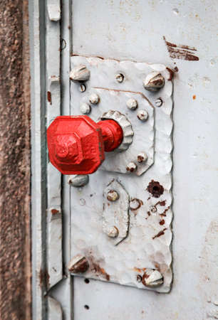 Detail of a door lock with a red knobの写真素材