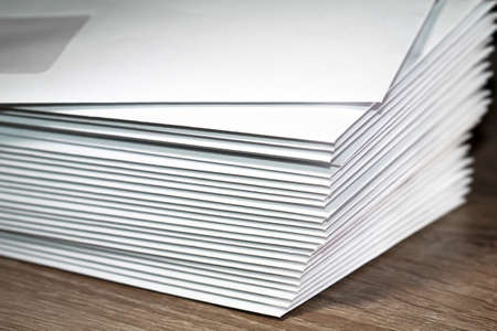 many white envelopes lying in a pile on the table