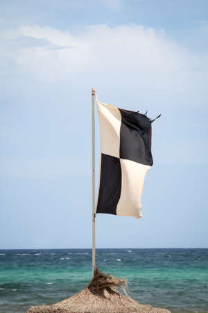 Flags on the beach indicate dangersの写真素材