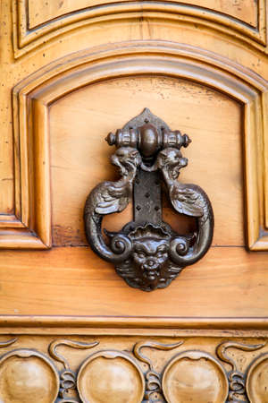 Old vintage door knocker as it used to be a bellの写真素材