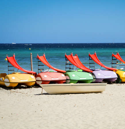 Pedal boats with slide on the beachの写真素材