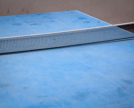 Details of a blue table tennis table with netの写真素材