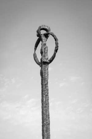 Old rusted metallic objects with a ringの写真素材