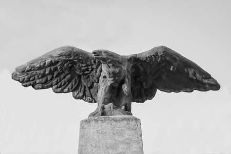 A stone eagle on the pedestal of a pillarの写真素材